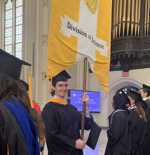 Braden Loughnane carring the Division of Science flag